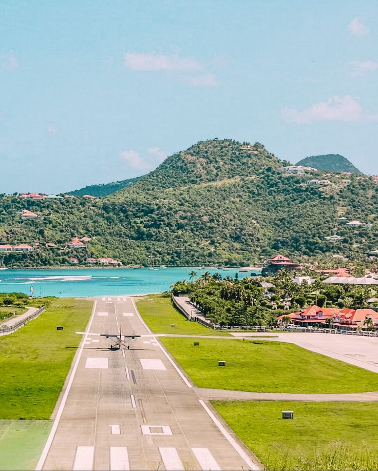 The runway seen along its axis on short final, the hillside rising on both flanks