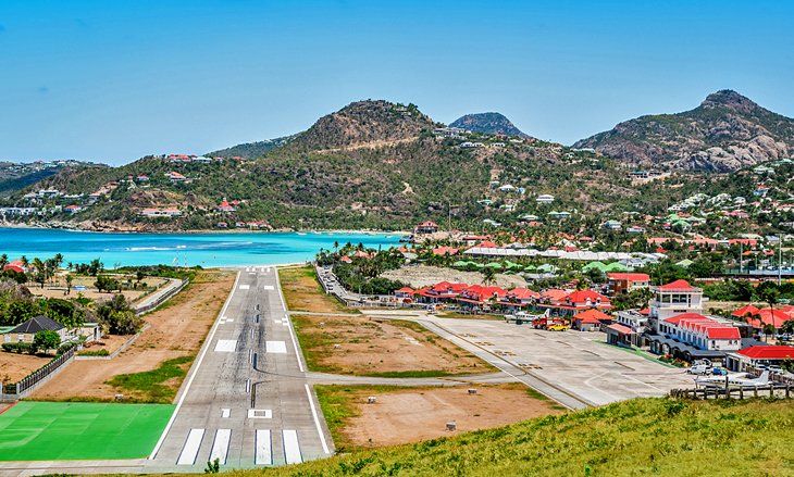 Saint-Barthelemy from above the ridge: the village, the bay and the runway running down to the water